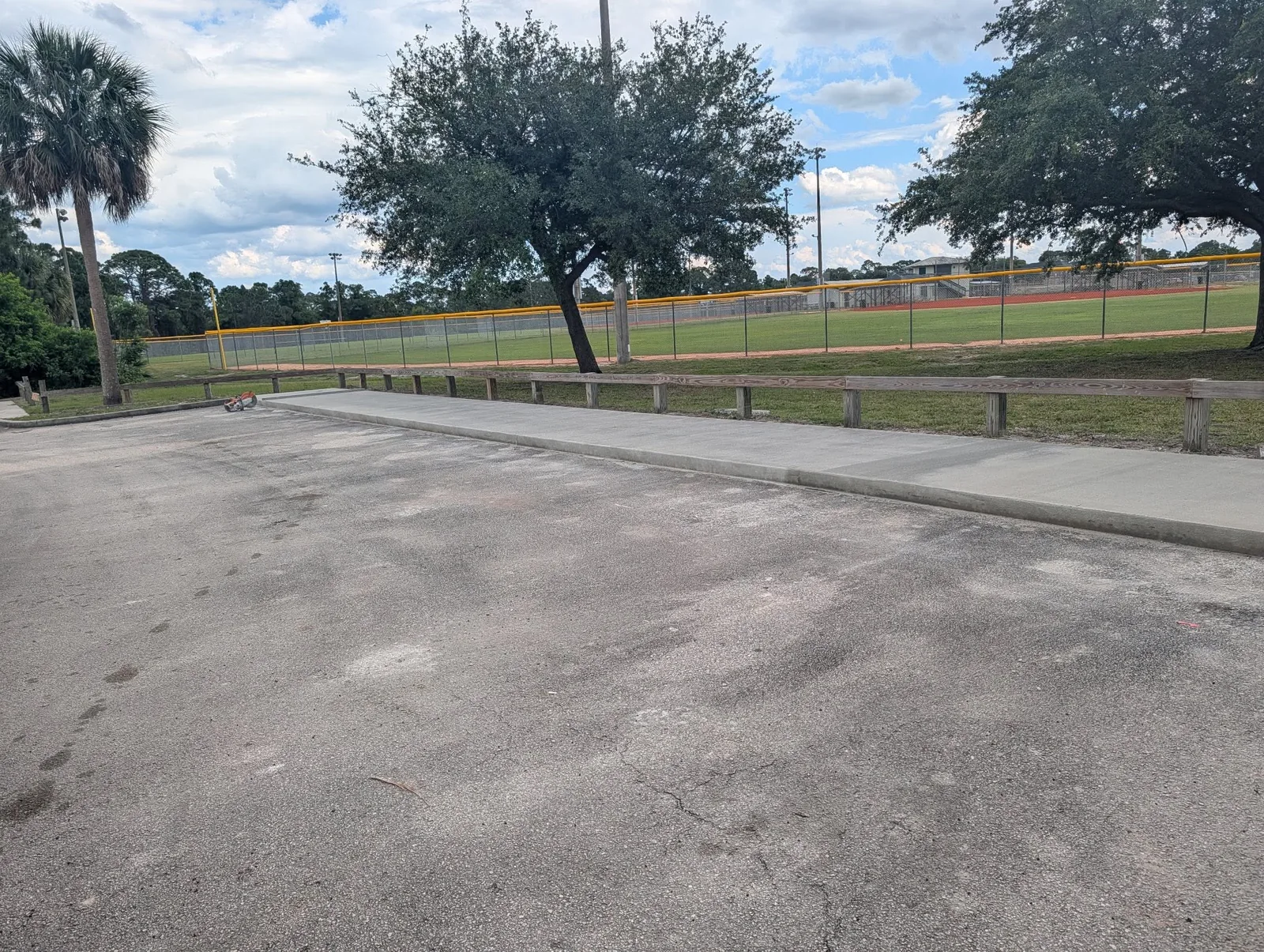 Completed JCD concrete walkway and curb beside a parking area