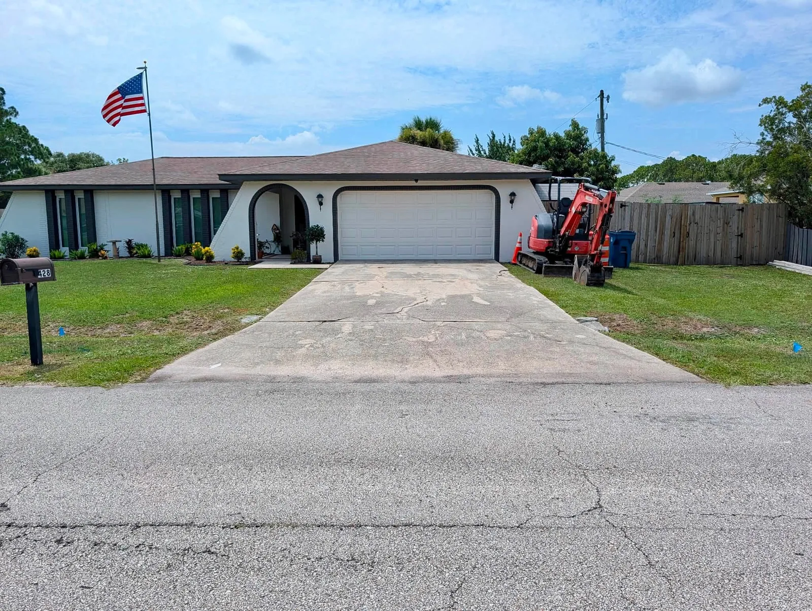 Cracked residential concrete driveway before replacement by JCD Concrete