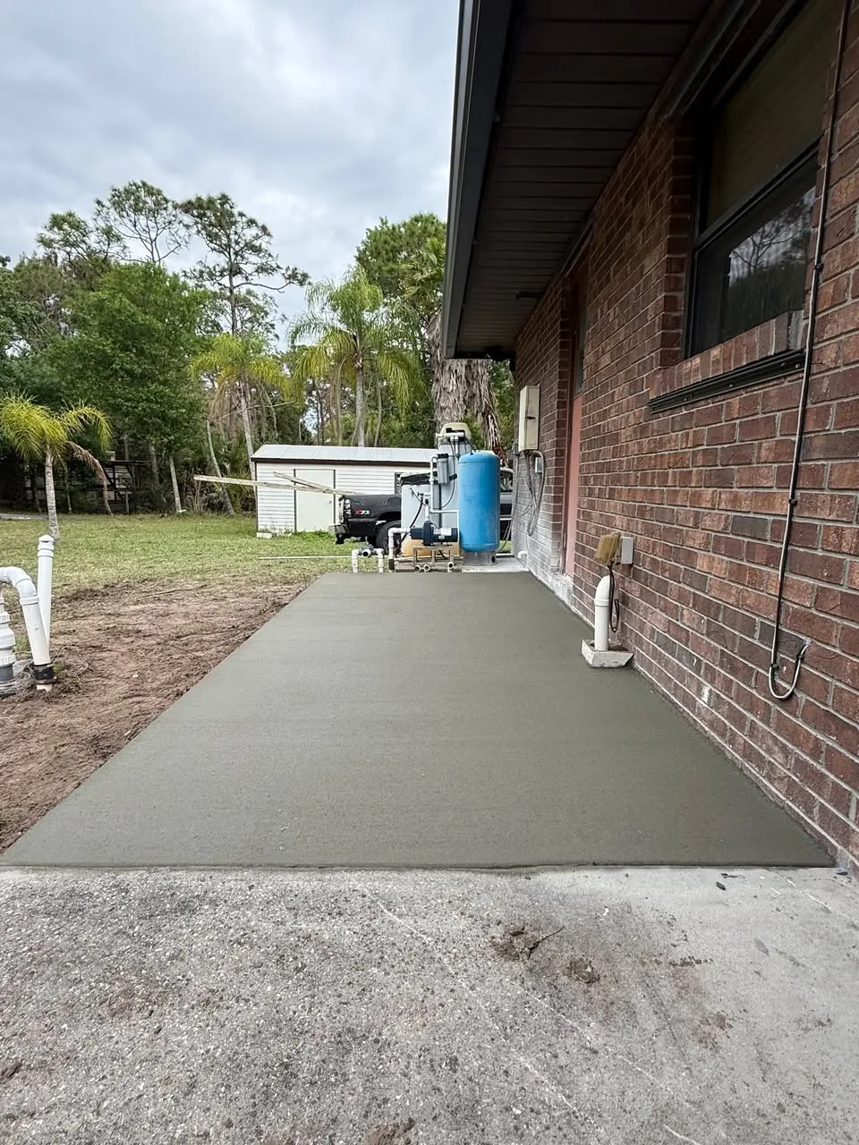 Long completed concrete sidewalk replacement beside a home